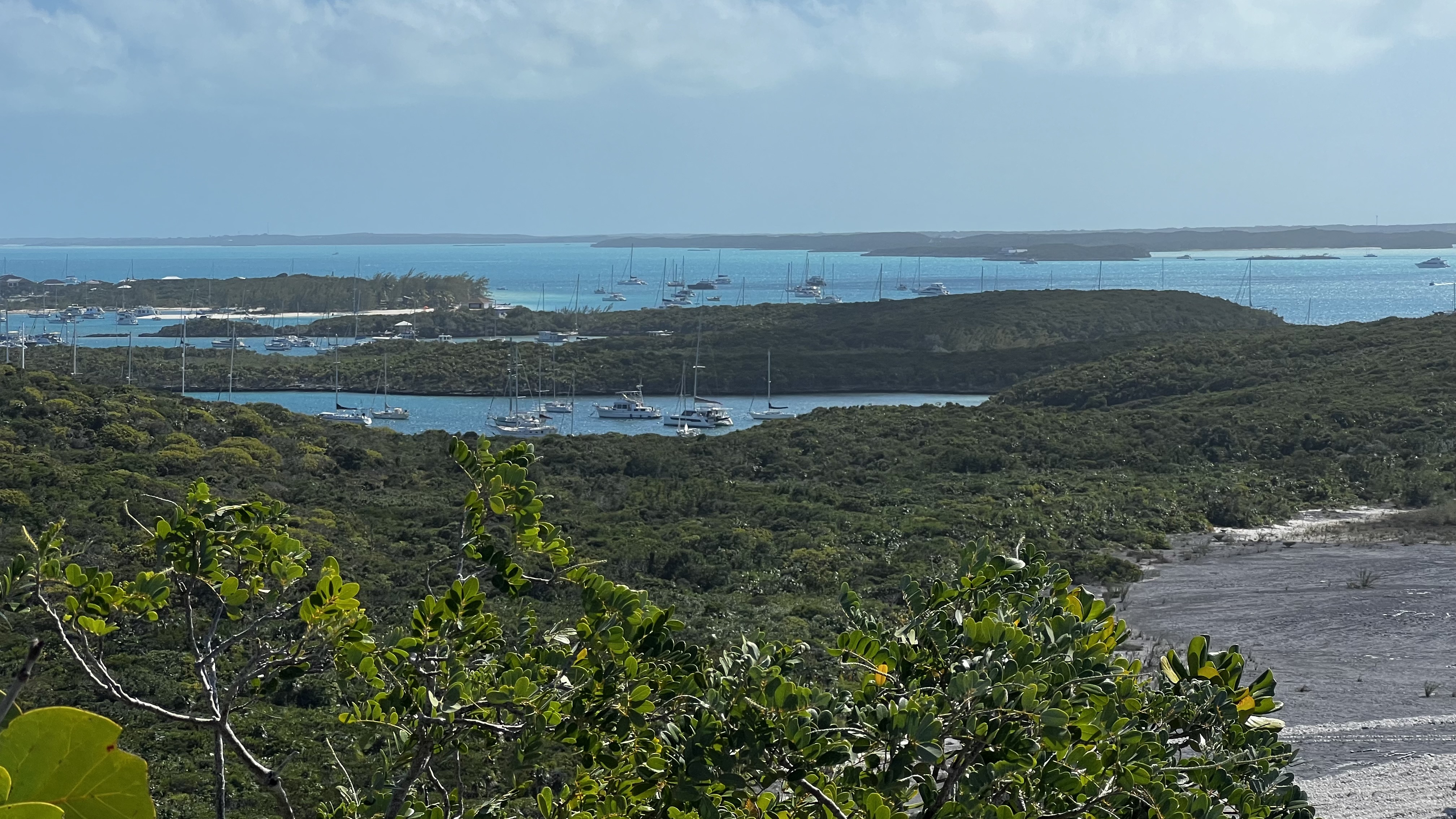 Looking south from Monument Hill. You can see the hurricane holes with moored boats and the Volleyball Beach mooring field in the more open water. George Town is over to the right.